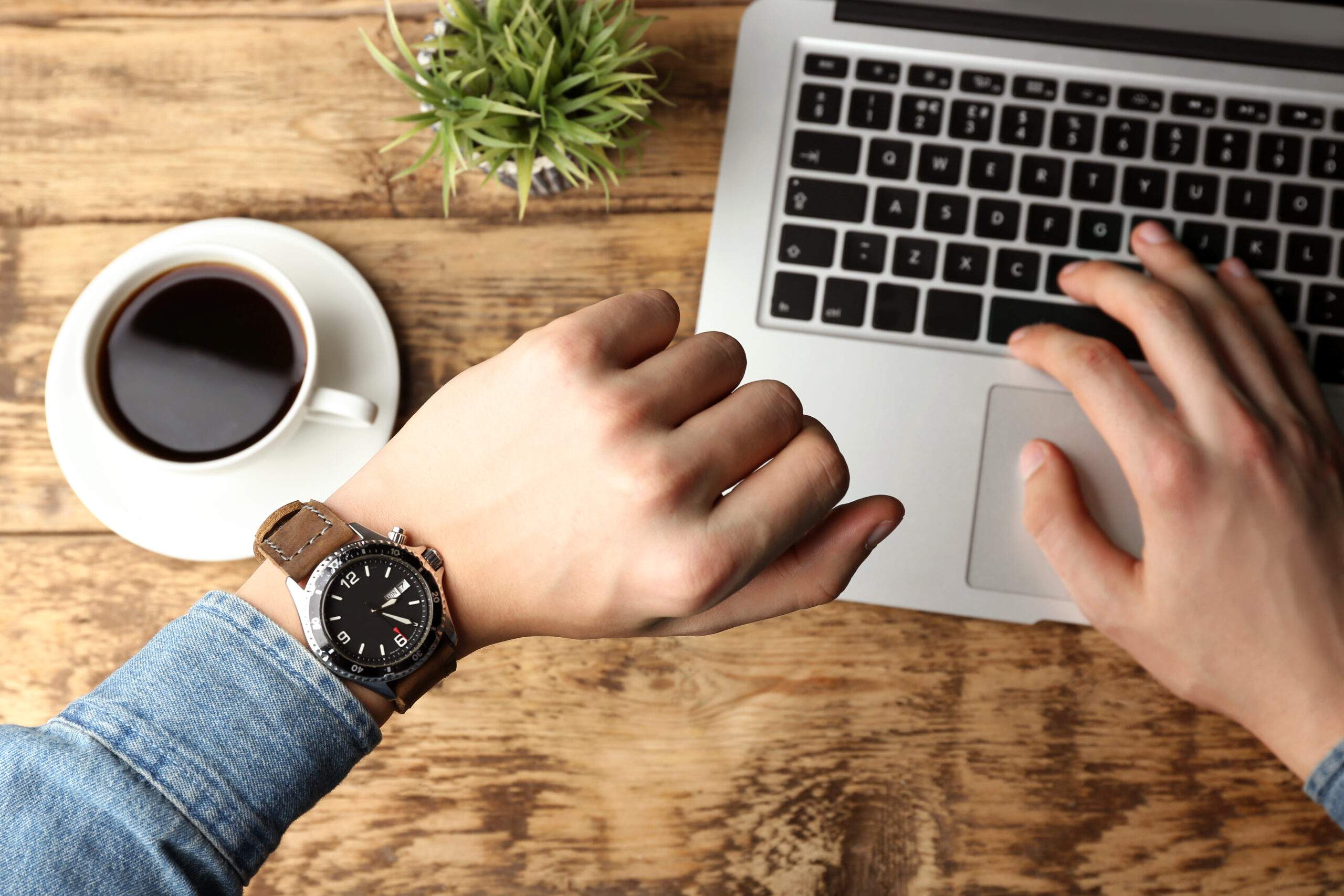 Hands,Of,Young,Man,Looking,At,Watch,While,Working,With | Power Marketing International how long does it take to design a website