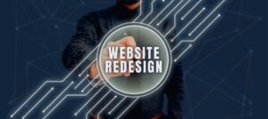 A person pointing at a glowing circular graphic that reads 'WEBSITE REDESIGN' with neon circuit lines in a dark blue background, conveying tech design.